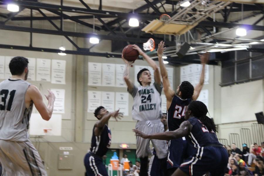 Jacques Carraway takes a turn around jump shot against CVC. 