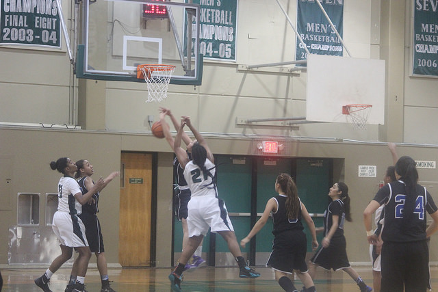 Forward Brandy Williams blocks a score in a Big 8 Tournament.