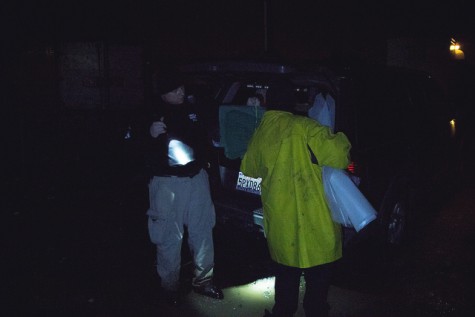 Doug Stewart from the Contra Costa Homeless Outreach Program rolls out some tarp for to bring to a homeless camp along the train tracks in North Richmond on 5 March.