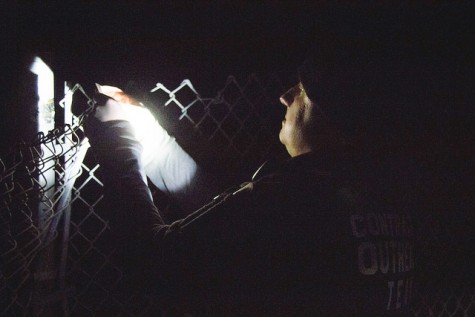 Doug Stewart from the Contra Costa County Homeless Outrach Program hikes down the train tracks and places his business card on a fence just outside of a homeless camp in North Richmond on 5 March.