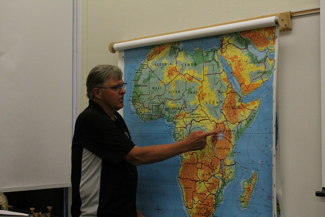 Professor Steve Johnson points to a region in Africa during a lesson.