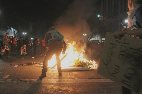 Fires burn during the anti-Trump protest in Oakland on Nov. 9, 2016
