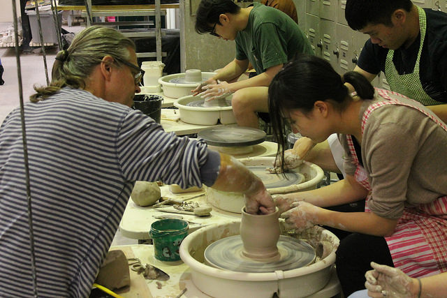 Ceramics instructor Mark Messenger helps Emma Wu craft a piece on the throwing wheel on November 3, 2016.