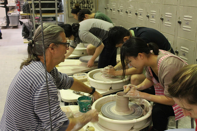 Ceramics instructor Mark Messenger helps Emma Wu craft a piece on the throwing wheel on November 3, 2016.