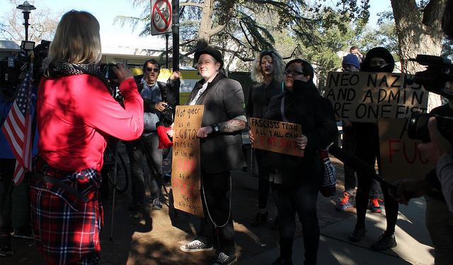 A supporter of Milo Yiannopoulos confronts a crowd of his critics at UC Davis on January 14, 2017. 