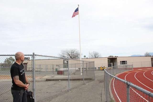 Student veteran Scott King looks on at the newly replaced flag in the DVC Vikings stadium.