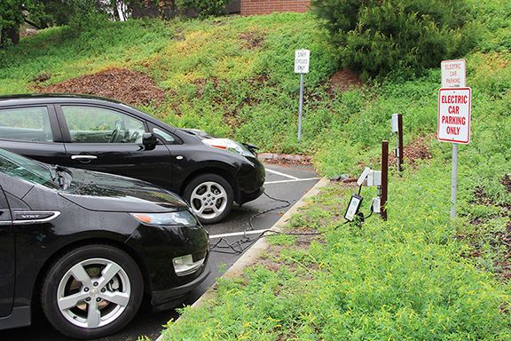 A Chevy Volt and Nissan Leaf charging in lot 4 at the only electric car outlet on campus. 