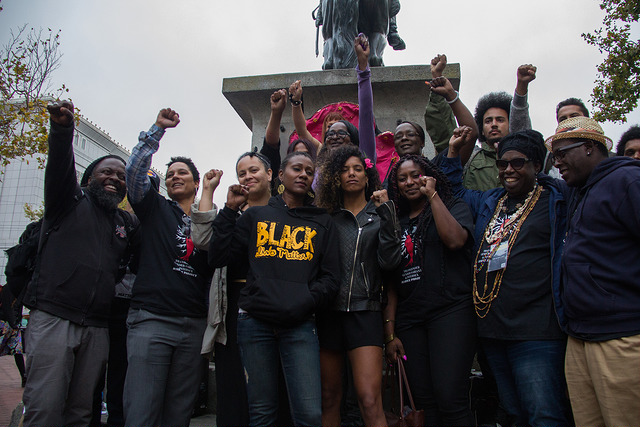 Members of the black lives matter movement stand with their fists raised after the end of the rally to stop violence against trans women of color held at the Civic Center Plaza on the 25th of August 2015 