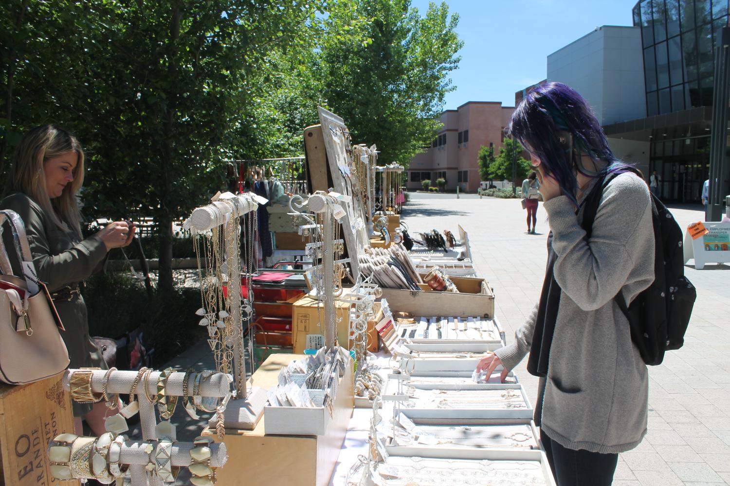A student looks at jewelry for sale from Suz and Bex on the DVC campus on April 27, 2017.