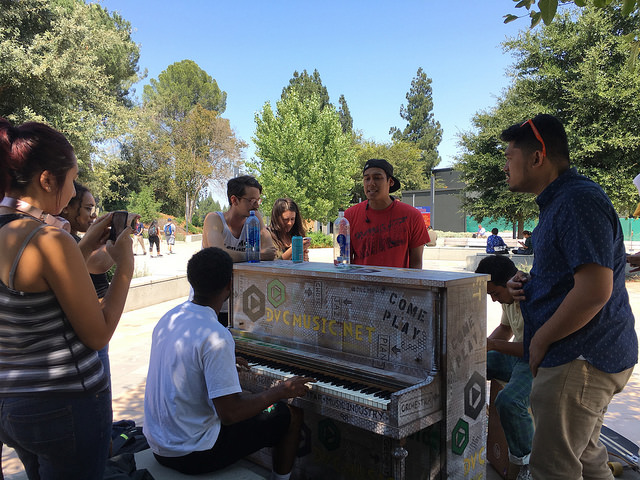 Students gather around the piano in The Commons in Pleasant HIll on August 17.