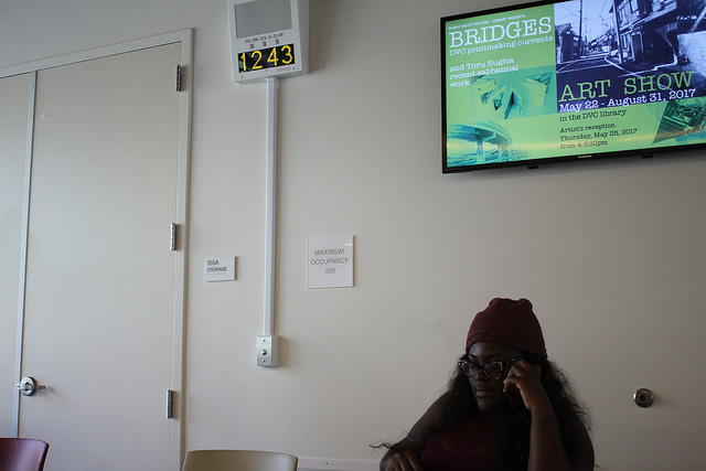 Jade Mayes sits next to the new PA system installed in the cafeteria on Aug. 23, 2017.