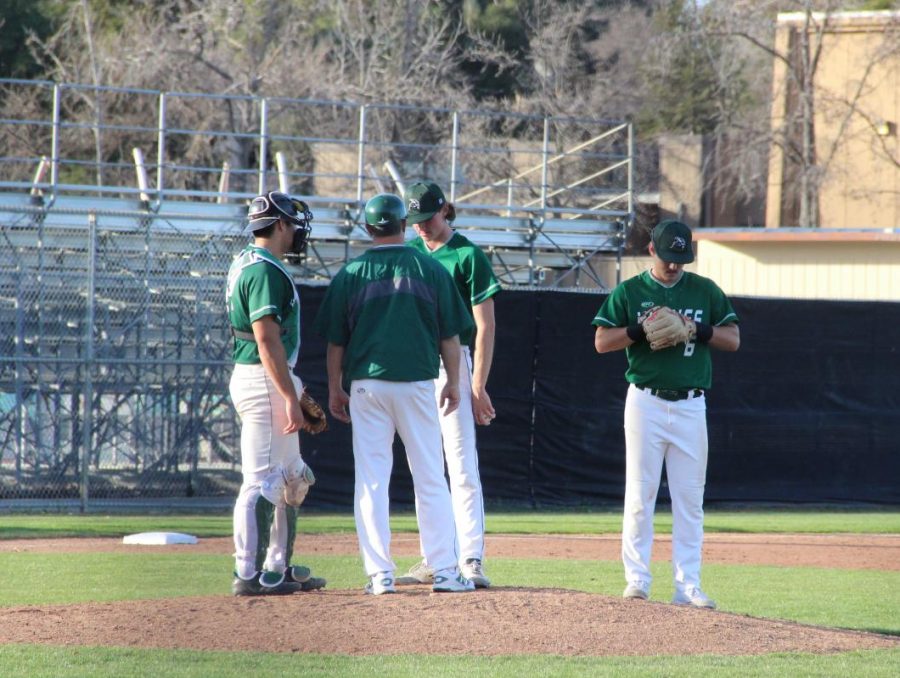A mound visit occurs after reliever Decklan Cashman gives up a key hit in the eighth inning against College of Marin at Diablo Valley College in Pleasant Hill, California on February 1, 2018.