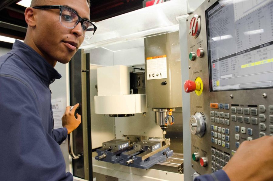 James Spencer works on an automated milling machine in the DVC machine shop on Tues, April 30th. As automated machines, like CNC ones, take over traditional manufacturing jobs, new jobs in programming and controlling them have arisen.
