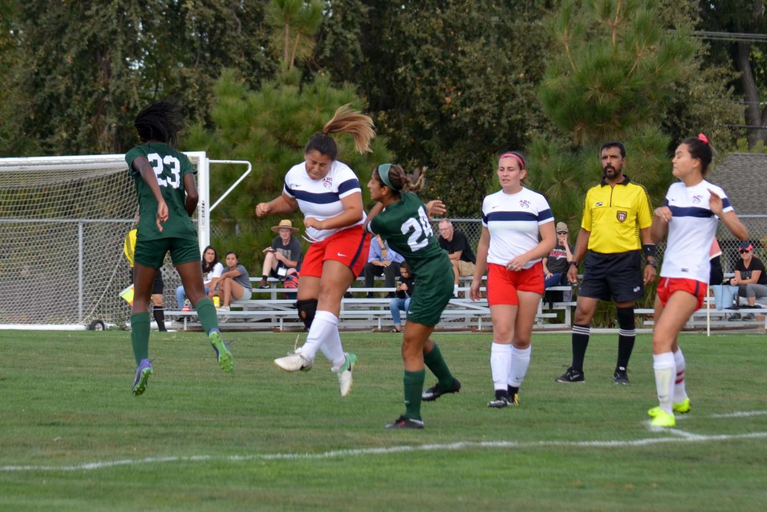 Forwards Alex Dusauzay (left) and Marjan Haydaree (right) of DVC women's soccer collide with an American River player during the game at the DVC field on Tuesday, Oct. 2, 2018. (Gavin Rock/The Inquirer)