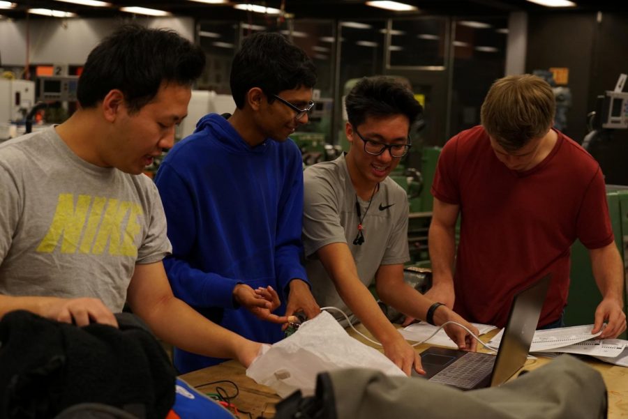 The electrical team tests the wiring connection between their new software and the power box.