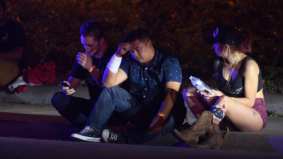 Fernan Diamse, center, cut his arm while breaking a window to escape the shooting Wednesday at the Borderline Bar and Grill in Thousand Oaks. (Photo courtesy of Mike Baker / For The Times)