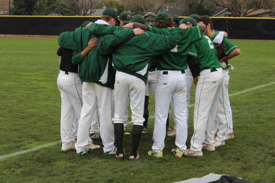 All of the baseball players huddle before the game.(Alex Martin/The Inquirer).