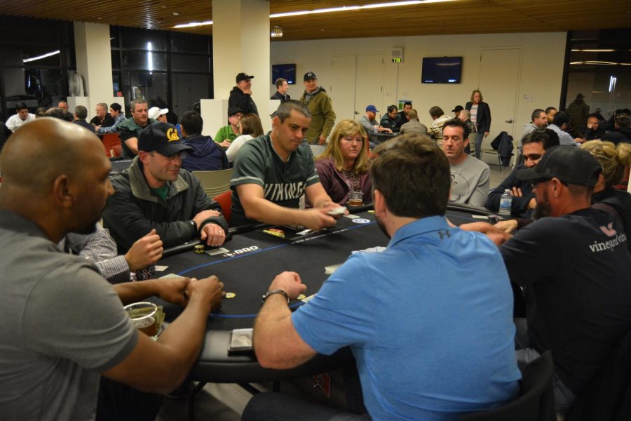 Jason Burke (Blue Dog Dealer) starts next round of poker at DVC Poker Night. (Samantha Laurey/The Inquirer).