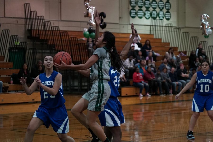 Freshman guard Jasmine Kong (center) scores a layup during the Vikings sophomore night game against Modesto. 