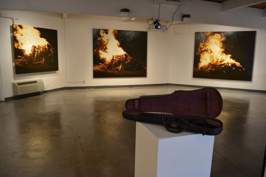 DVC art gallery showing paintings and burnt violin for art show at Pleasant Hill campus. (Samantha Laurey/The Inquirer).