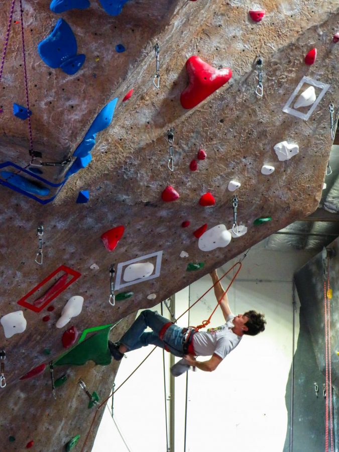 A Touchstone Climbing Series competitor chalks up before his next big move. (Pavlina MarkovaThe Inquirer).