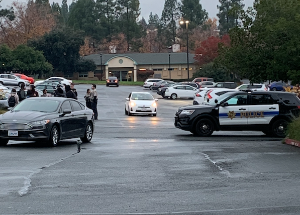 Police investigating the scene in the parking lot Wednesday afternoon. (Emma Hall/The Inquirer)