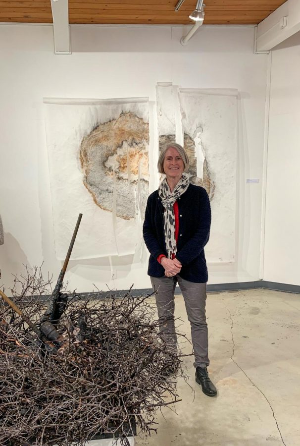 Eve Werner with two pieces of art she contributed to the gallery (Autumn Jarmel/The Inquirer).