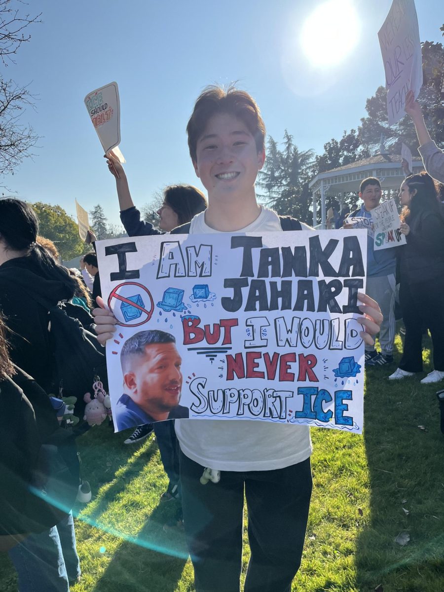Benicia senior Evan Magno holding Anti-ICE sign